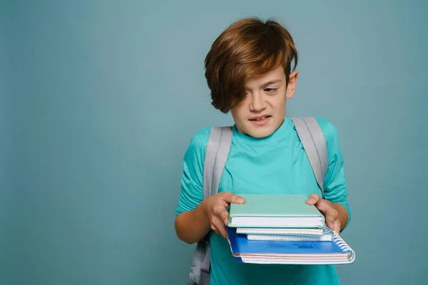 Ginger Displeased Boy Backpack Posing Exercise Books Isolated Blue Wall — Stockfoto