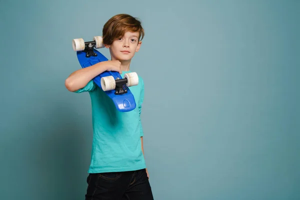 Ginger White Boy Looking Camera While Posing Skateboard Isolated Blue — Foto de Stock