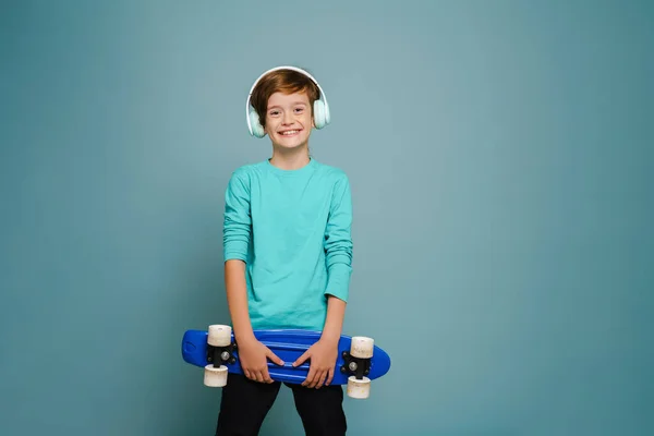Ginger White Boy Headphones Smiling While Posing Skateboard Isolated Blue — Foto de Stock