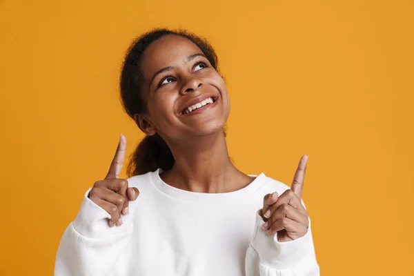 Brunette Black Girl Smiling While Pointing Fingers Upward Isolated Yellow — Fotografia de Stock