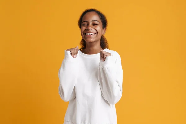 Brunette Black Girl Laughing While Holding Clenched Fists Isolated Yellow — Stockfoto