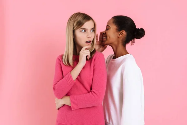 Black Girl Smiling While Whispering Secret Shocked Friend Isolated Pink — 스톡 사진