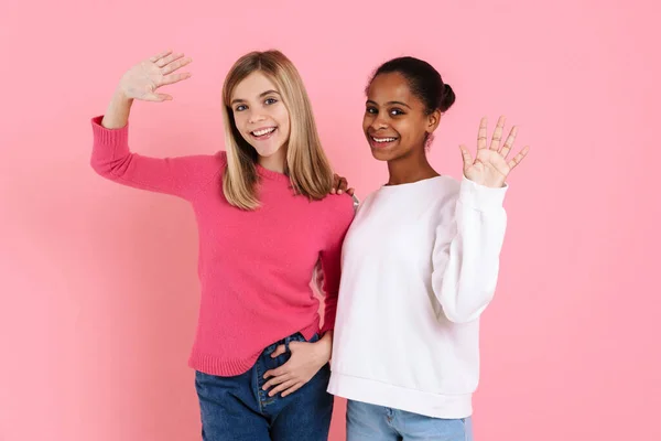 Multiracial Two Girls Wearing Sweaters Smiling Waving Hands Together Isolated — ストック写真