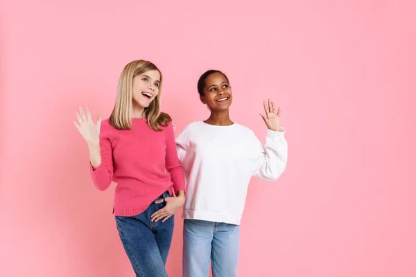 Multiracial Two Girls Wearing Sweaters Smiling Waving Hands Together Isolated — ストック写真
