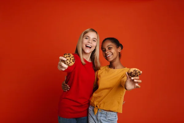 Multiracial Two Girls Hugging While Making Fun Cookies Isolated Red — ストック写真