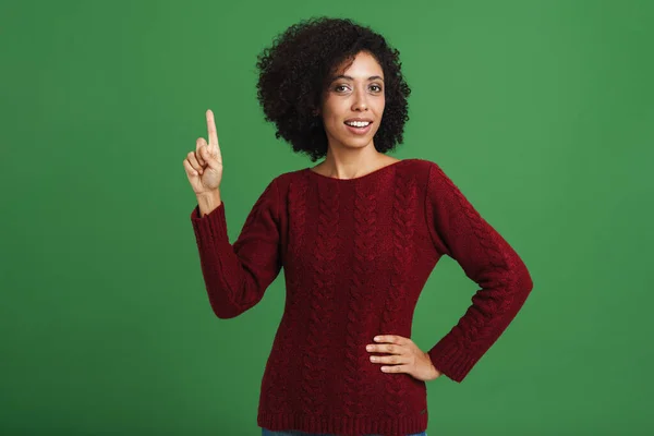 Black Young Woman Wearing Sweater Pointing Finger Upward Isolated Green — Stockfoto