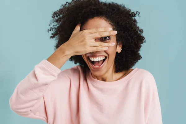 Black Young Woman Laughing While Covering Her Eyes Isolated Blue —  Fotos de Stock