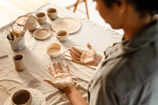 Young Black Ceramist Woman Looking Her Hands While Working Her — ストック写真
