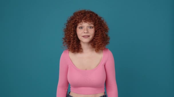 Cute Curly Haired Redhead Woman Wearing Pink Shirt Looking Camera — Wideo stockowe