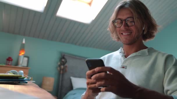 Smiling Blond Man Typing Phone Home Indoors — Video Stock