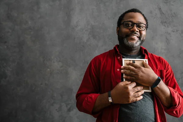 Black Man Eyeglasses Smiling Holding Photo Frame While Standing Concrete — Stock fotografie