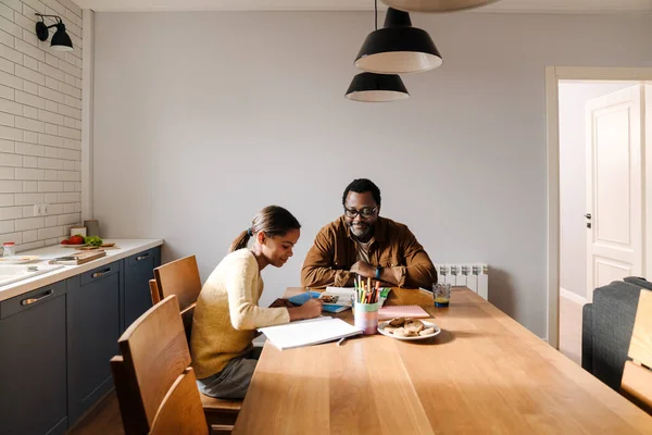 Black Girl Smiling While Doing Homework Her Father Home — Stok Foto