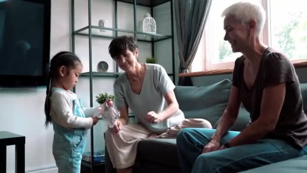 Cheerful Mature Lesbian Couple Playing Adopted Asian Daughter Indoors Home — Stockvideo
