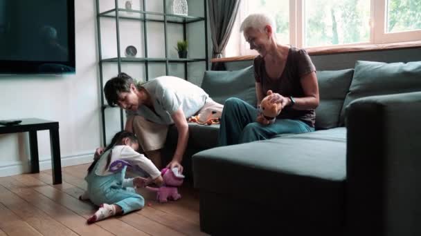 Smiling Mature Lesbian Couple Playing Adopted Asian Daughter Indoors Home — Vídeo de stock