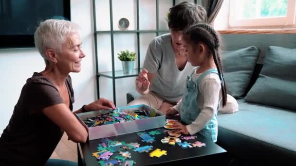 Smiling Mature Lesbian Couple Talking Putting Puzzles Together Adopted Asian — Stockvideo