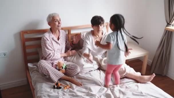 Lovely Mature Lesbian Couple Playing Adopted Asian Daughter Bed Home — Stockvideo