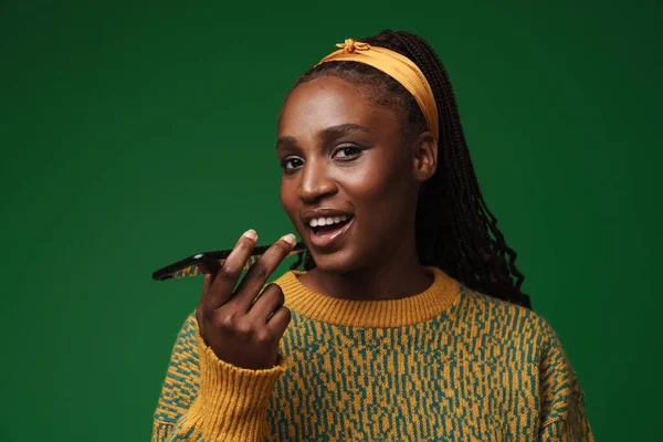 Black Young Woman Pigtails Smiling While Talking Cellphone Isolated Green — Zdjęcie stockowe