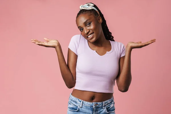 Black Young Woman Pigtails Smiling Holding Copyspace Isolated Pink Wall — ストック写真