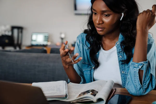 Black Young Woman Earphones Using Laptop While Doing Homework Home — Stockfoto
