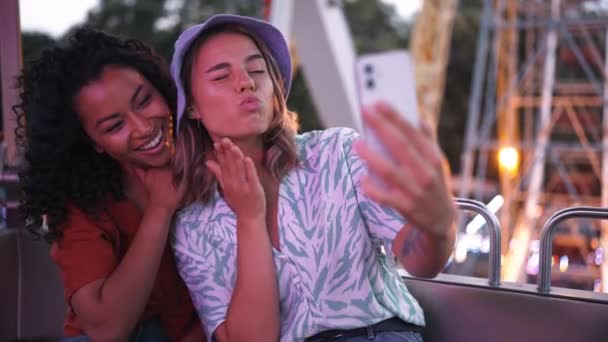 Two Pretty Multinational Young Women Making Selfie Photo While Riding — Video Stock