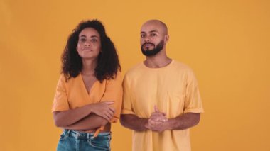Positive hispanic couple agreeing on something in the yellow studio