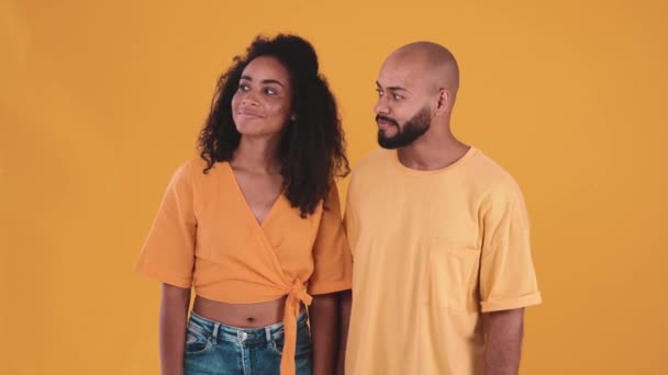 Positive Hispanic Couple Looking Showing Silence Gesture Yellow Studio — Wideo stockowe