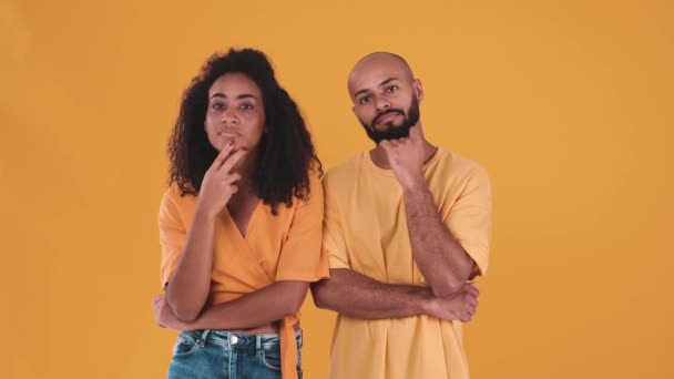 Pensive Hispanic Couple Looking Thinking Yellow Studio – stockvideo