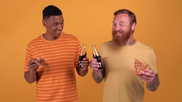 Pleased Multinational Men Eating Pizza Drinking Sweet Water While Standing — Wideo stockowe