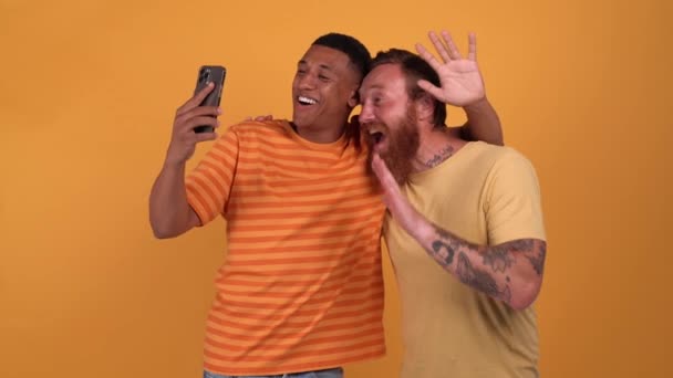 Cheerful Multinational Men Talking Video Call Phone While Standing Yellow — Vídeo de Stock