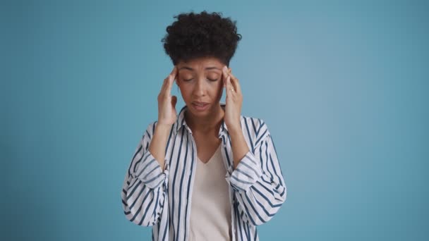 Sad Hispanic Curly Haired Woman Suffering Headache Blue Studio — Stock video