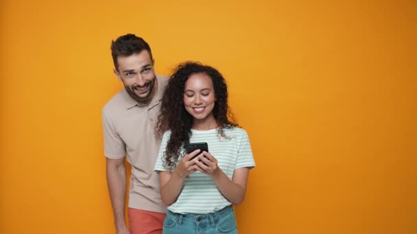 Positive Man Closes Eyes His Girlfriend Who Texting Phone Yellow — Stockvideo