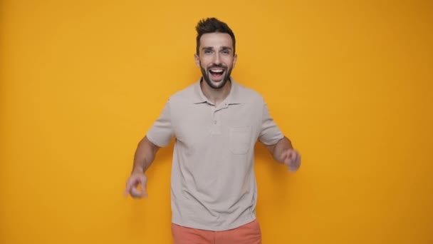 Cheerful Brunet Man Wearing Shirt Pointing Fingers Upwards Looking Camera — Stock video