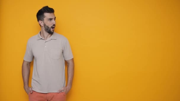 Shocked Brunet Man Wearing Shirt Looking Copyspace Yellow Studio — Stock video