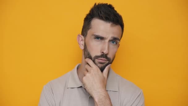 Serious Brunet Man Wearing Shirt Thinking Something While Standing Yellow — Stock video