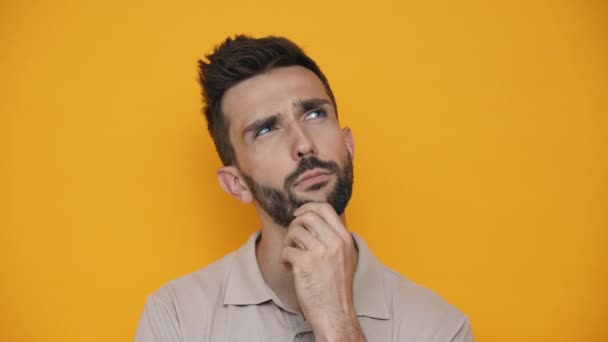 Confident Brunet Man Wearing Shirt Thinking Something While Standing Yellow — Stock video