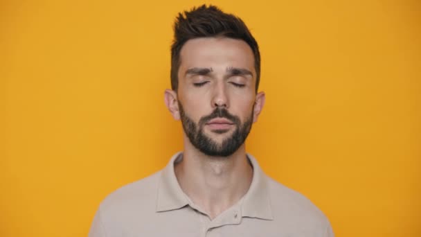 Concentrated Brunet Man Wearing Shirt Opening Eyes Camera Yellow Studio — Stock Video