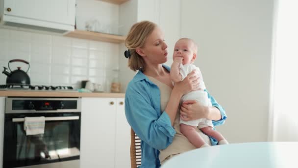 Positive Blonde Mother Playing Small Child Chair Kitchen — Vídeo de stock