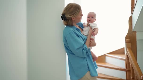 Happy Blonde Mother Talking Small Child Her Arms Indoors Home — Wideo stockowe