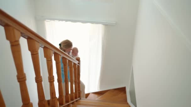 Cheerful Blonde Mother Walks Stairs Her Small Child Her Arms — Wideo stockowe