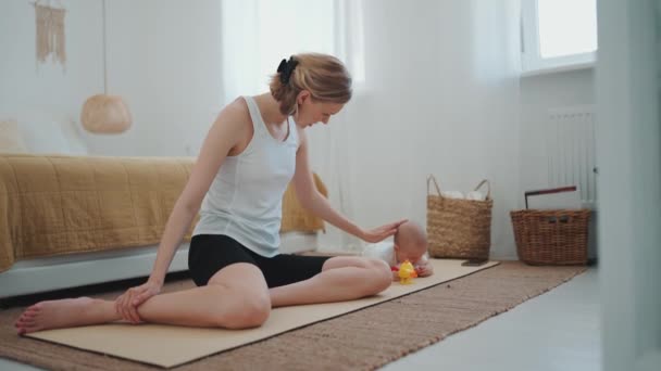 Positive Blonde Mother Stroking Her Small Child Lying Her Yoga — Stockvideo