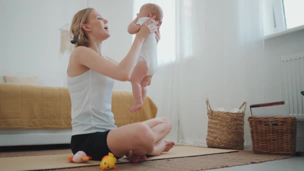 Funny Blonde Mother Playing Her Small Child Yoga Exercise Home — Wideo stockowe