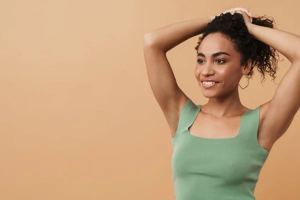 Young Black Woman Holding Her Hair While Smiling Camera Isolated — Stockfoto