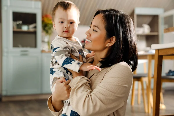 Happy Mother Smiling While Holding Her Son Kitchen Home — Stock Photo, Image