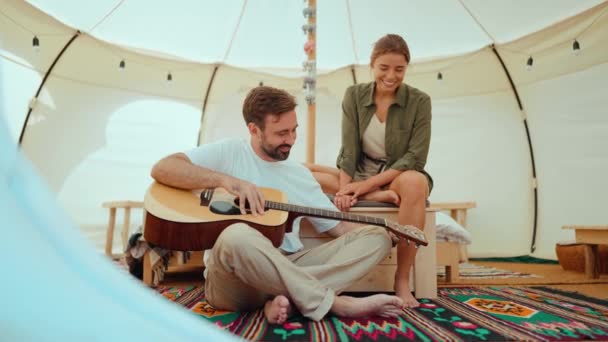 Preciosa Pareja Joven Rubia Tocando Guitarra Hablando Mientras Está Sentado — Vídeos de Stock