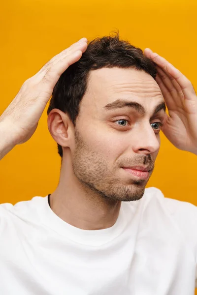 Close Portrait Man Touching His Hair Standing Isolated Orange Background — Stock Photo, Image