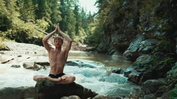 Handsome Red Haired Man Doing Yoga Meditation Stone Running River — Stock Video