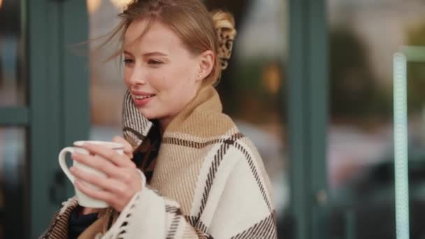 Pretty Blonde Woman Covered Blanket Standing Cup Tea Cafe Outdoors — Stock Video