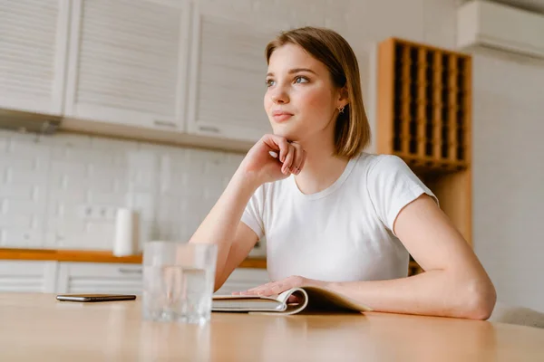 Smiling Young Woman Writing Her Diary While Sitting Kitchen Table — Stock Photo, Image