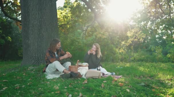 Pareja Joven Positiva Comiendo Croissants Picnic Parque — Vídeo de stock