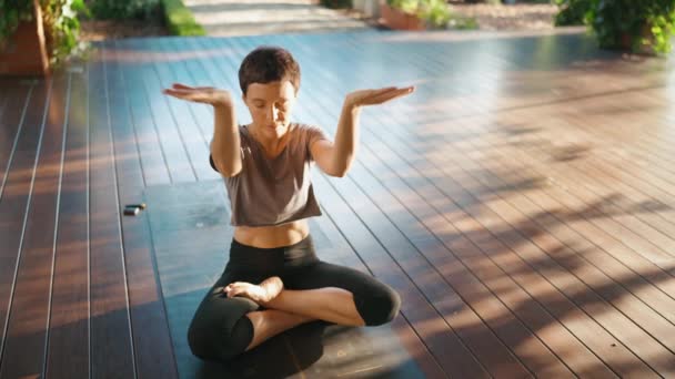 Pleased Short Haired Woman Meditating Closed Eyes Lotus Position Outdoors — Stock Video